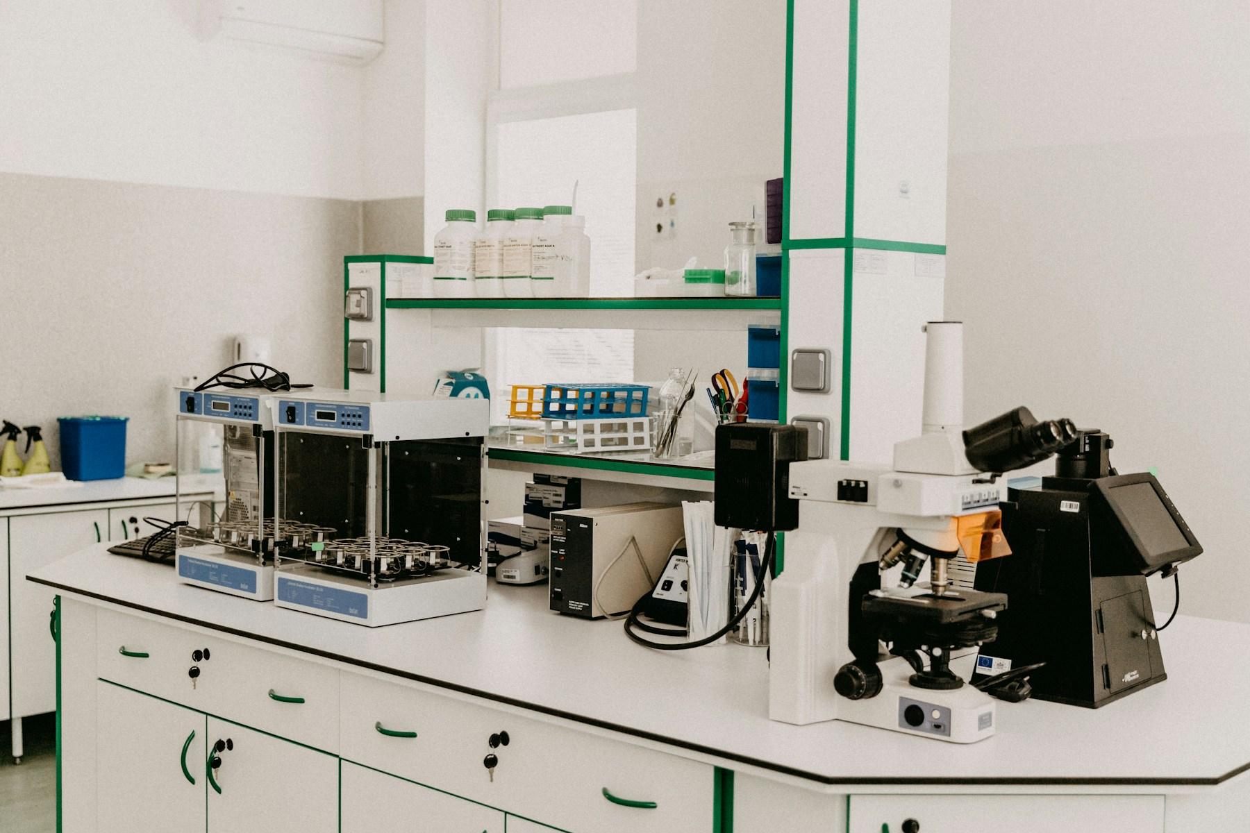 A bright teaching laboratory bench with a microscope and analytical instruments